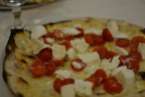 Hmmm delicious pizza with thin crispy crust and fresh tomatoes and mozzarella